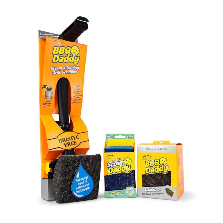 Scrub grill cleaner kit featuring the BBQ Daddy steam grill brush in orange packaging with a black handle, replacement cleaning pads, refill box, and a silver mesh cloth laid out together.