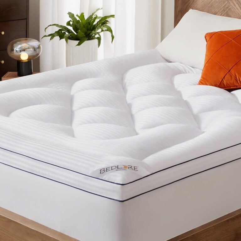White quilted mattress topper with pillow-top cushioned squares on modern bed with orange accent pillow