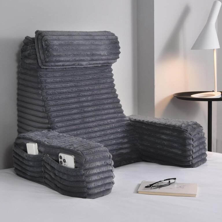 Charcoal grey ENITYA reading pillow with high backrest, padded armrests, and side pockets in modern grey room