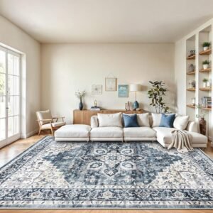 Large navy blue and cream vintage Persian washable area rug in modern living room with white sectional sofa