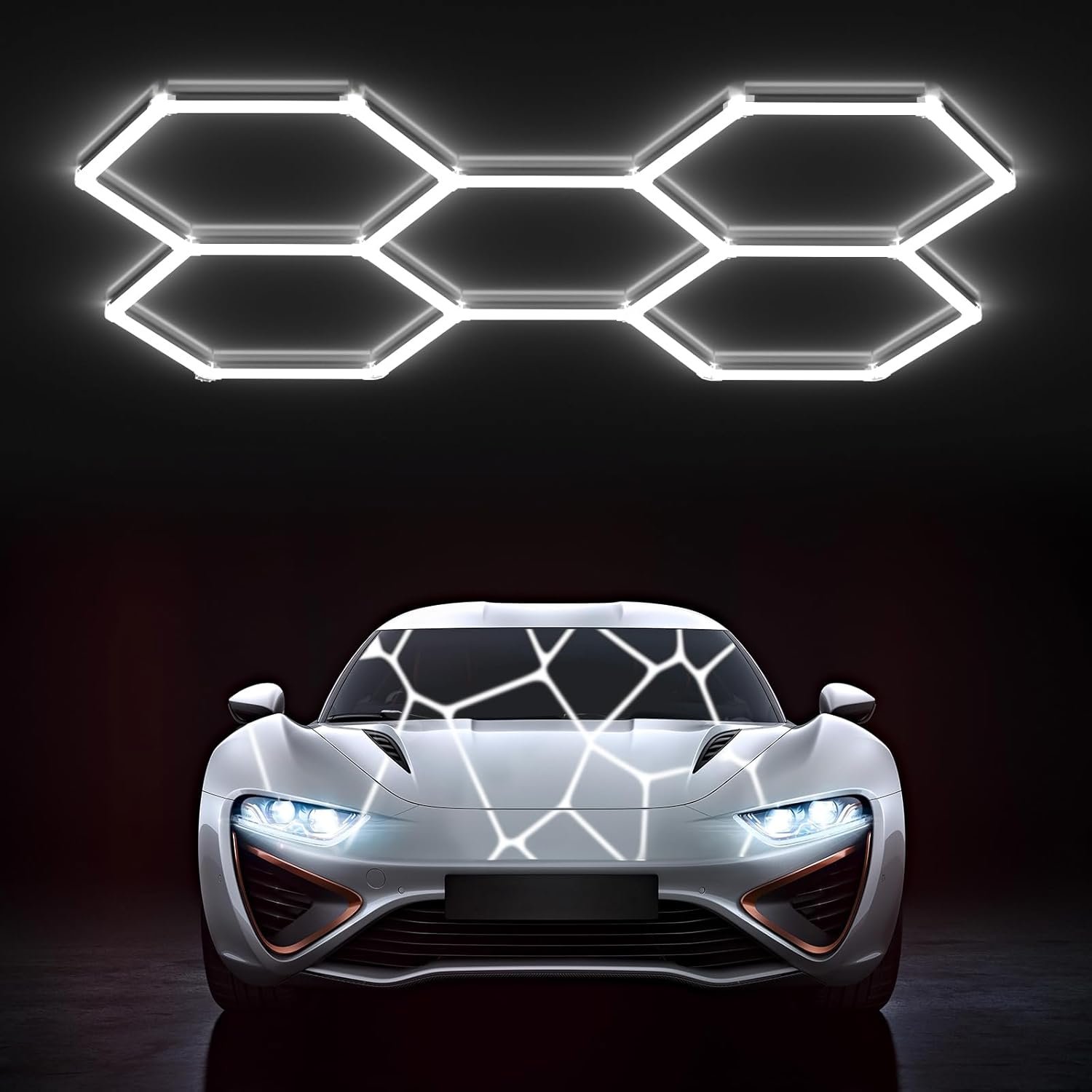 Six white Hexagon LED Light Gen 2 panels linked in honeycomb pattern glowing bright white above silver sports car in dark garage