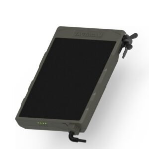 Olive green Tactacam Defend security camera with solar panel and LED indicators, mounted on tree in outdoor setting for remote monitoring